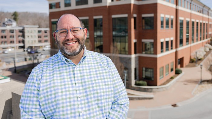 Dr. Andrew Koricich, executive director of the Alliance for Research on Regional Colleges, stands in front of Appalachian State University’s Reich College of Education.