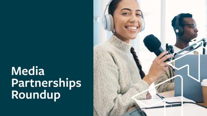 A smiling woman wears headphones and holds a microphone as she records a podcast. Media Partnerships Roundup.