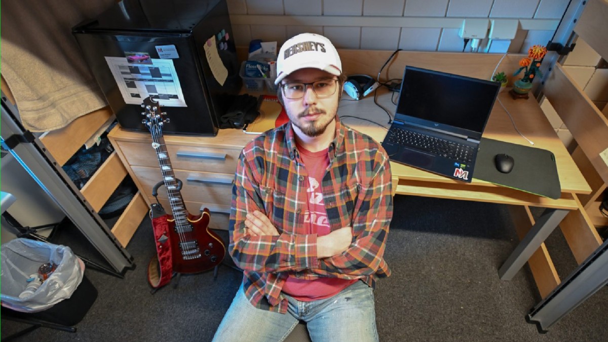 A freshman at Minnesota State University Moorhead sits in his cramped dorm room.