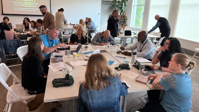 The president of the Community Education Coalition speaks with economic development partners during one of their collaboration institutes.