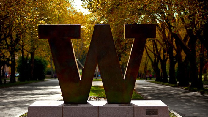 A large “W” sculpture on an autumn day at the University of Washington college campus.