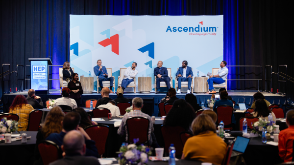 Facilitator Dr. Toya Barnes-Teamer, panelists Josh Stoltz, Shannon Ross, Darryl Epps, Kiana Calloway, and moderator Robert Samuels sit on stage in front of an Ascendium backdrop during the HEP Grantee Convening.